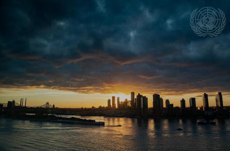 Photo: The Sun rises behind Long Island City skyscrapers at dawn of the first day of the general debate of the General Assembly's seventy-sixth session (2021). UN Photo/Mark Garten