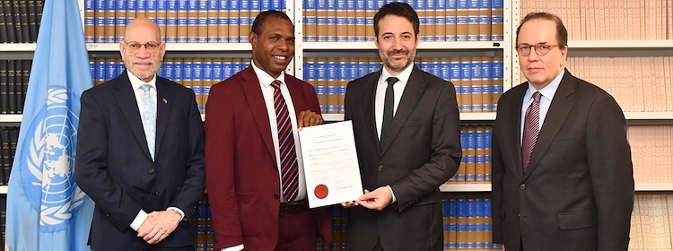 L-R) Ambassador Fred Sarufa, the Chargé d'Affaires of Papua New Guinea to the United Nations 1st from links, Jason Peter, the country's Minister for Community Development, Youth, and Religion, David Nanopoulos, the Chief of the Treaty Section at the UN Office of Legal Affairs.