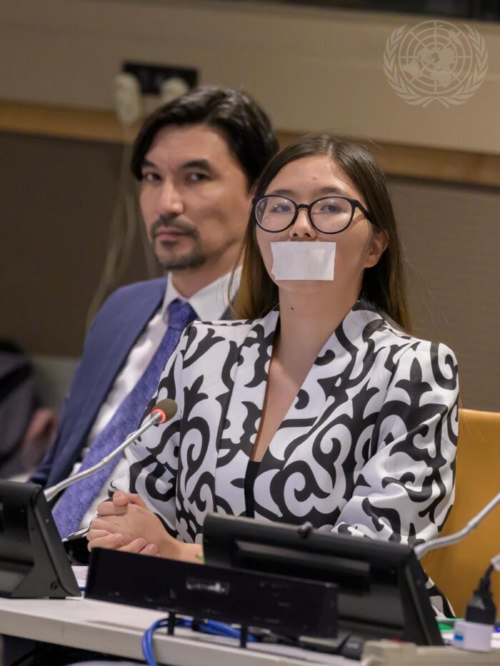 Alimzhan Akmetov(Left), and Diana Murzagaliyeva(Right), a fourth-generation survivor of nuclear testing, taped her mouth shut, representing the years she spent unable to speak. Photo credit: UN Photo/Manuel Elías