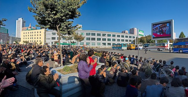 Photo: People in Pyongyang watch Kim Jong-un on North Korean TV, 2015. Credit: Wikimedia Commons.