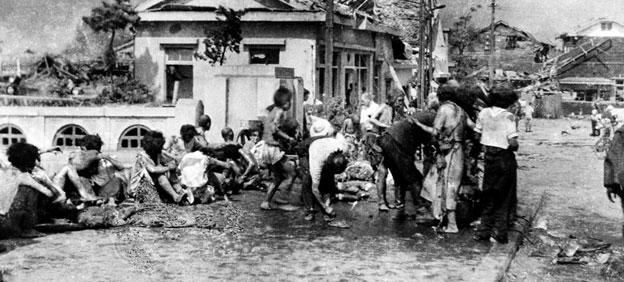 Injured civilians, having escaped the raging inferno, gathered on a pavement west of Miyuki-bashi in Hiroshima, Japan, at about 11 a.m. on 6 August 1945. Credit: UN Photo/Yoshito Matsushige
